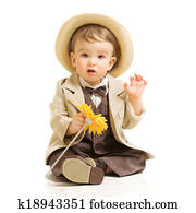 Baby boy well dressed in suit with flower. Vintage children style, white background