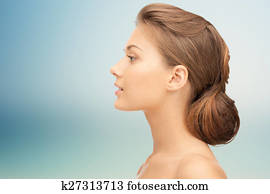 beautiful young woman face over blue background beautiful young woman face over blue background