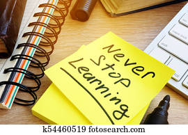 Never stop learning written on a memo stick. Lifelong learning concept. Never stop learning written on a memo stick. Lifelong learning concept.