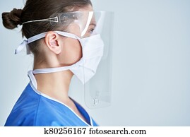 Portrait of female medical doctor wearing protective mask and face shield Portrait of female medical doctor wearing protective mask and face shield