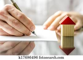 Man signing a contract when buying a new house Man signing a contract when buying a new house