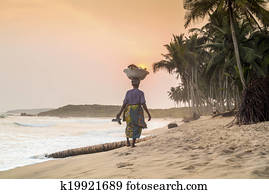African woman walking on beautiful beach