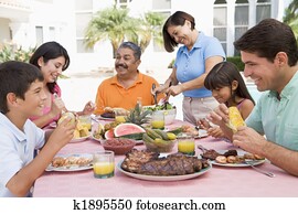 Family Enjoying A Barbeque Family Enjoying A Barbeque