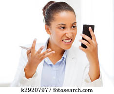african woman shouting into smartphone