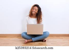 African American student girl using a laptop computer - black pe