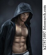 Muscular and handsome athlete making muscles Muscular and handsome athlete making muscles