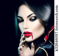 Beauty sexy vampire girl with dripping blood on her mouth Beauty sexy vampire girl with dripping blood on her mouth