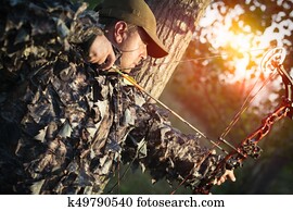 hunter with bow hunting in the forest hunter with bow hunting in the forest
