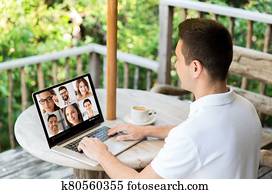 man with laptop having video call with colleagues man with laptop having video call with colleagues