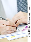 Office worker writing on reports