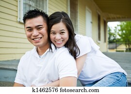 https://cdn-grid.fotosearch.com/CSP/CSP146/asian-couple-in-front-of-their-house-stock-photograph__k1462576.jpg