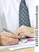 Office worker writing on reports