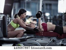 Female personal trainer helping Female personal trainer helping