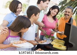 Family Enjoying A Barbeque Family Enjoying A Barbeque