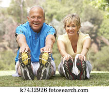 Senior Couple Exercising In Park