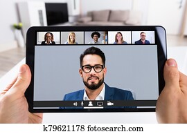 Person Video Conferencing With Doctor On Digital Tablet Person Video Conferencing With Doctor On Digital Tablet