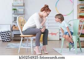 Boy with counselor in classroom