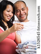 Happy expecting asian couple