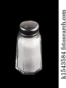 Salt shaker on black background