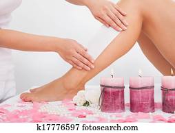 Beautician Waxing A Woman's Leg Beautician Waxing A Woman's Leg