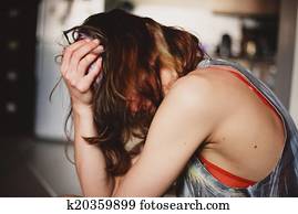 Sad woman at home with a head ache