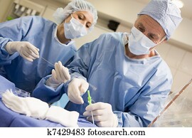 Surgeons Preparing Equipment For Surgery Surgeons Preparing Equipment For Surgery