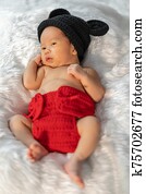 newborn baby in mouse costume on fur bed newborn baby in mouse costume on fur bed