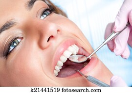 Dentist working on girls teeth