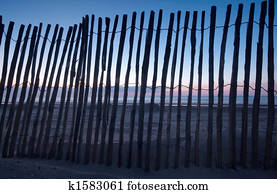 wooden fence on the beach