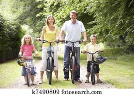 Family riding bikes in countryside
