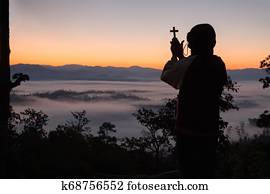 silueta, de, mão humana, segurando, a, crucifixos, a, fundo, é, a, sunrise., conceito, para, cristão, cristianismo, católico, religião, divino, heavenly, celestial, ou, god.