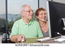senior couple using computer senior couple using computer