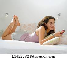 teenager girl bed cell phone