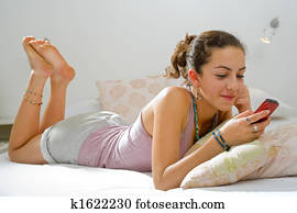 teenager girl bed cell phone