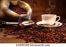 Coffee cup with burlap sack of roasted beans 