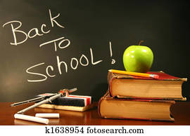 School books with apple on desk School books with apple on desk
