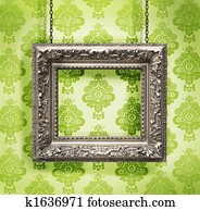 Silver picture frame hung against floral wallpaper background Silver picture frame hung against floral wallpaper background