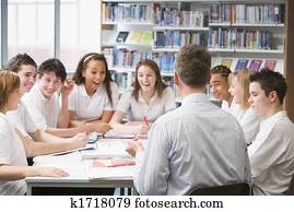 Students and teacher in a study group collaborating Students and teacher in a study group collaborating