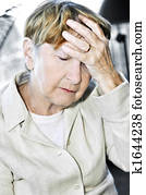 Elderly woman holding head