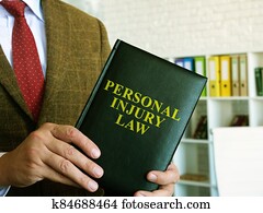 Personal injury law. A lawyer in a suit holds a book. Personal injury law. A lawyer in a suit holds a book.