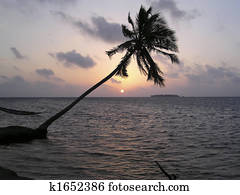 Sunset on a tropical beach on Maldives Islands
