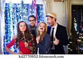 Hipster friends celebrating New Years Eve together, photobooth p Hipster friends celebrating New Years Eve together, photobooth p