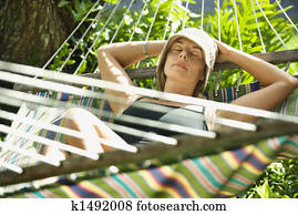 Woman relaxing in hammock.
