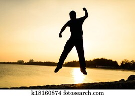 young man jumping off a cliff with his powerful feeling