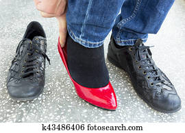 Man putting on red ladies shoes Man putting on red ladies shoes
