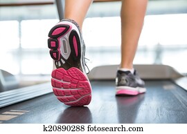 Womans feet running on the treadmill Womans feet running on the treadmill