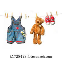 Child's clothes with teddy bear on clothesline