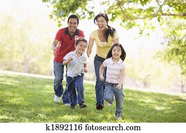 Family running outdoors smiling Family running outdoors smiling