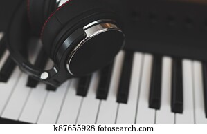 Headphones on the piano keyboard. Recording studio concept.