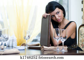 Woman in restaurent in anticipation of
